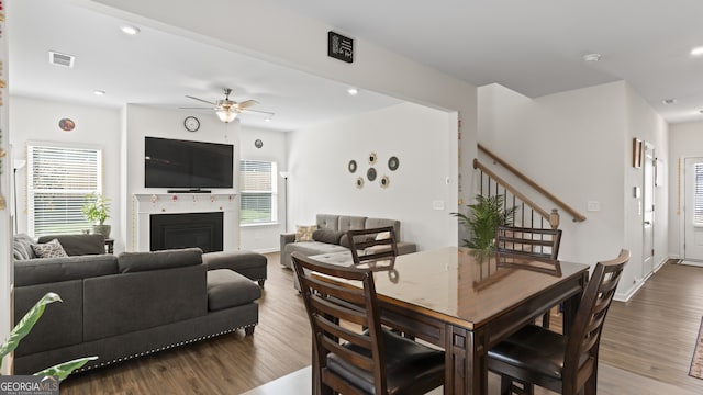 dining area featuring ceiling fan, a healthy amount of sunlight, and hardwood / wood-style flooring