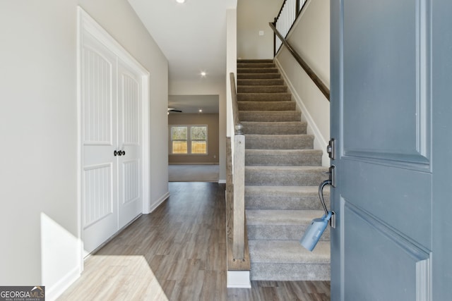 stairs featuring recessed lighting, baseboards, and wood finished floors