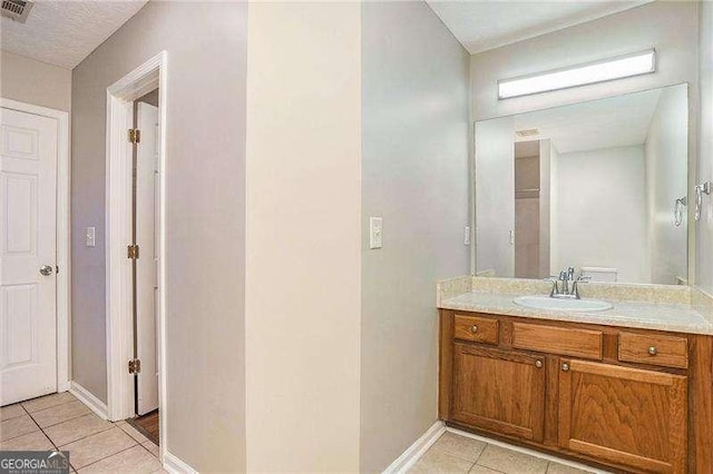 bathroom with tile patterned flooring and vanity