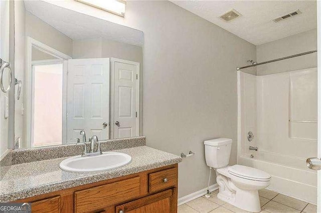 full bathroom with vanity, tile patterned floors, toilet, a textured ceiling, and shower / bathtub combination