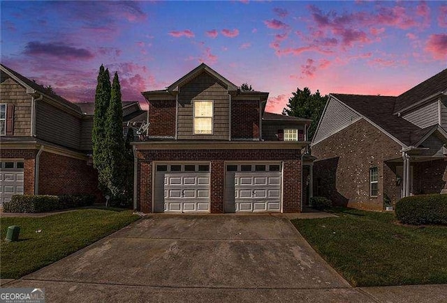 front of property featuring a yard and a garage