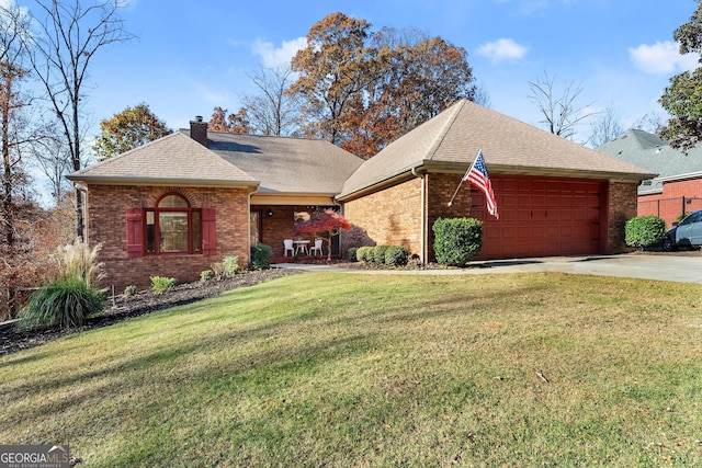 view of front of home with a garage and a front yard