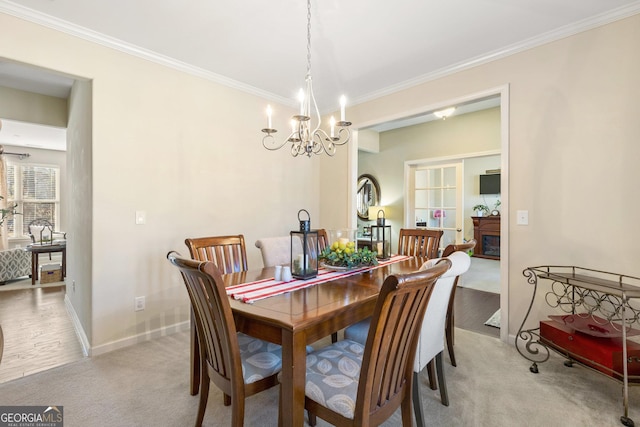 carpeted dining space with crown molding