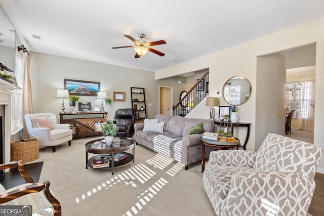 living room with ceiling fan and light colored carpet