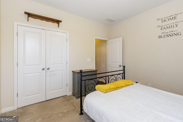 bedroom with light colored carpet and a closet