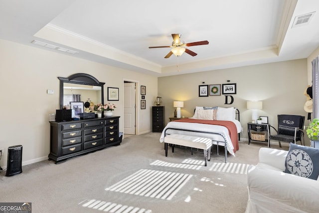 bedroom featuring crown molding, ceiling fan, a raised ceiling, and light carpet