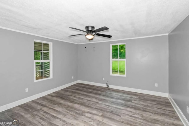 unfurnished room with hardwood / wood-style floors, a textured ceiling, ceiling fan, and ornamental molding