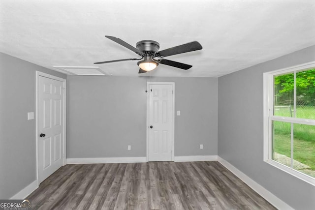 unfurnished room with ceiling fan and dark wood-type flooring