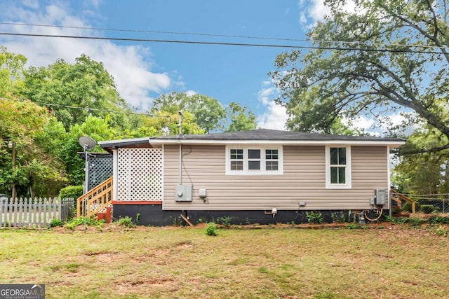 view of side of home with a lawn