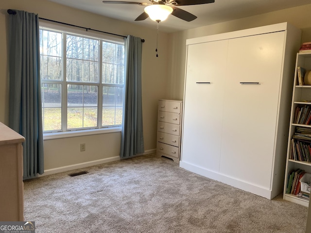 unfurnished bedroom with ceiling fan and light carpet