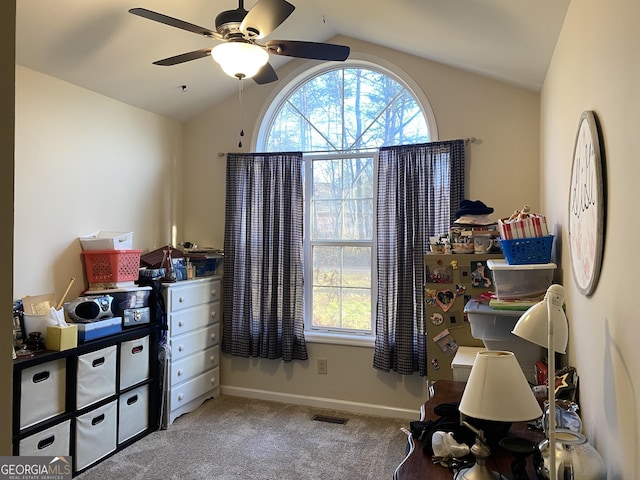 office area with a wealth of natural light, ceiling fan, light colored carpet, and lofted ceiling