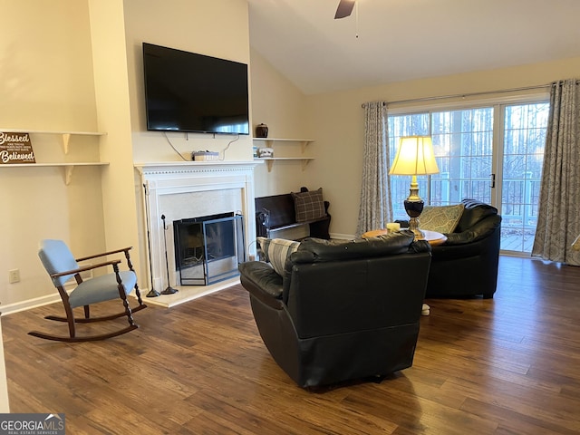 living room featuring hardwood / wood-style flooring, ceiling fan, and vaulted ceiling