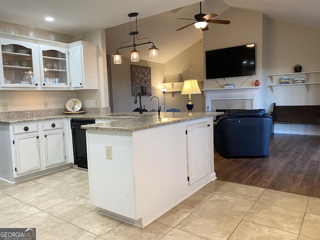 kitchen with sink, pendant lighting, white cabinetry, lofted ceiling, and light tile patterned flooring