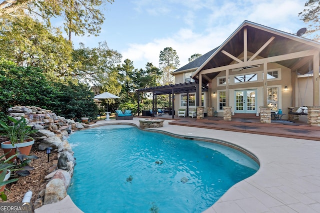 view of pool featuring french doors, a patio, and a pergola