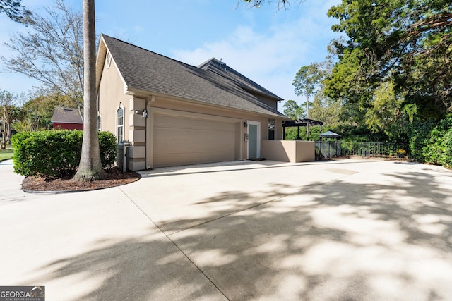 view of side of home featuring a garage