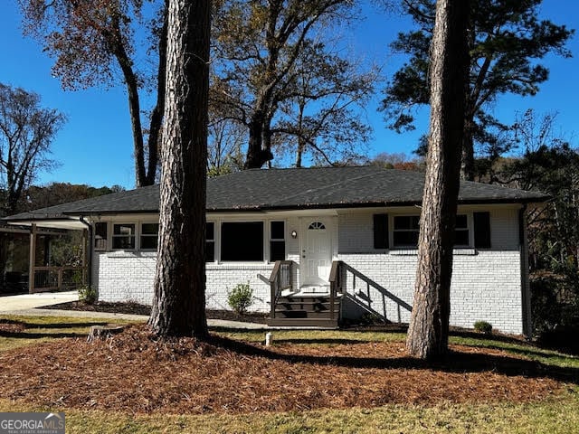 single story home featuring a carport