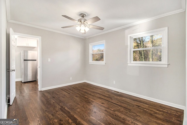 unfurnished room with crown molding, ceiling fan, and dark wood-type flooring