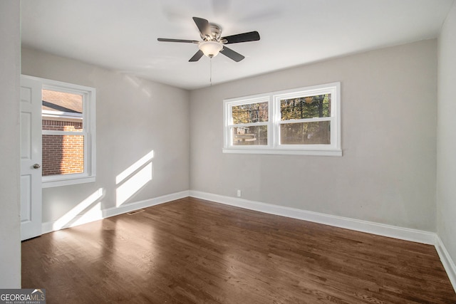 empty room featuring ceiling fan and dark hardwood / wood-style flooring