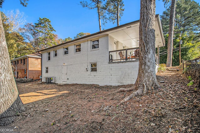 rear view of property featuring central AC