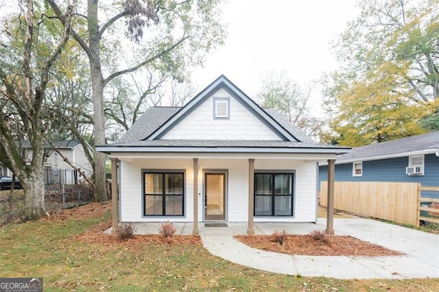 view of front of property with a porch and a front lawn