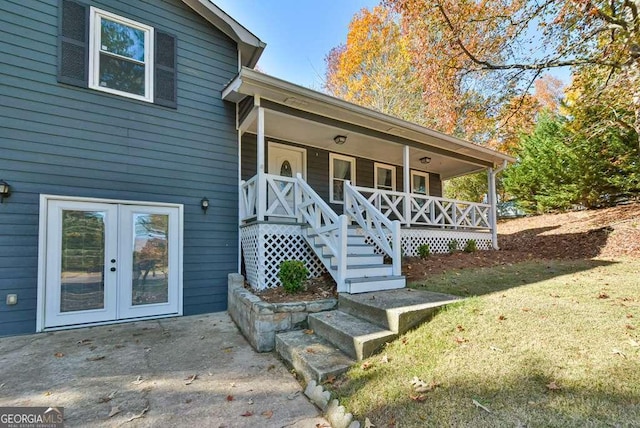 entrance to property with french doors and a porch