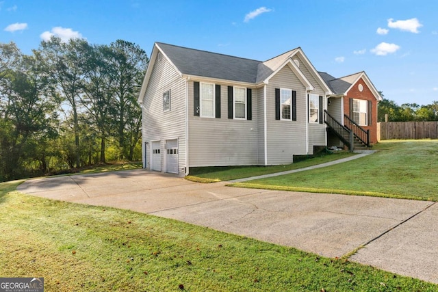 view of front of house with a front yard and a garage