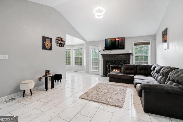 living room featuring a fireplace and vaulted ceiling