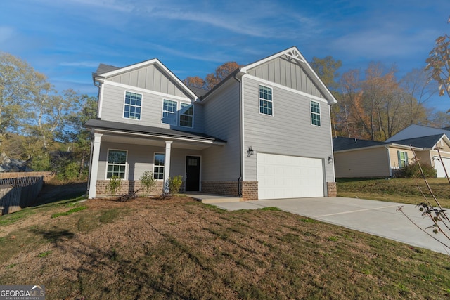 view of front of home with a porch, a garage, and a front lawn