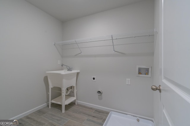 laundry room with light hardwood / wood-style floors, washer hookup, and hookup for an electric dryer