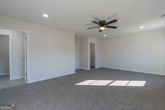 carpeted spare room featuring ceiling fan