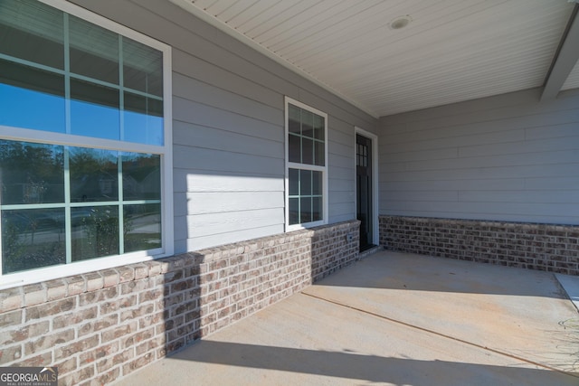 view of exterior entry with a porch