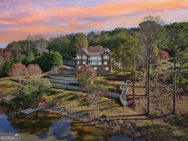 back house at dusk with a water view