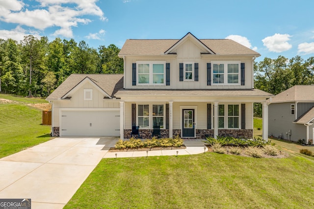 craftsman inspired home featuring a front yard, a garage, and covered porch