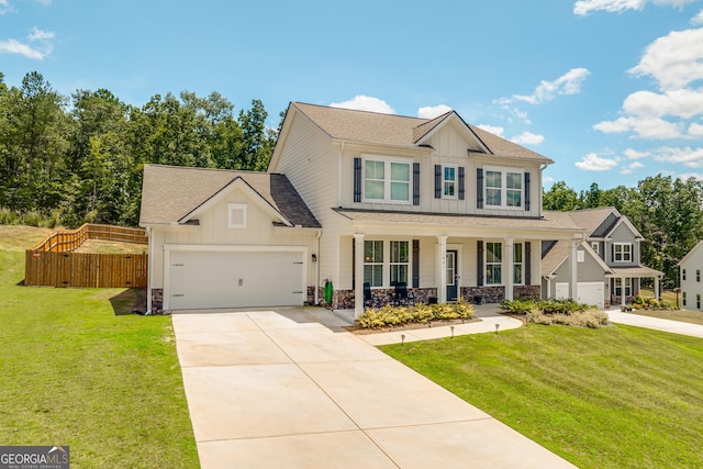 view of front of home featuring a porch, a garage, and a front yard