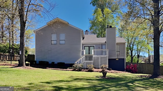 back of property featuring a lawn