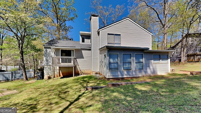 rear view of property with a lawn