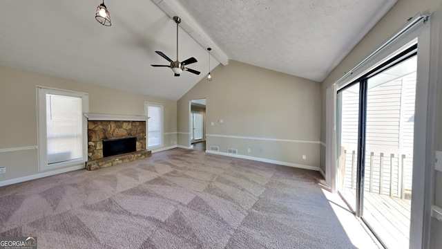 unfurnished living room with ceiling fan, a fireplace, light colored carpet, and lofted ceiling with beams