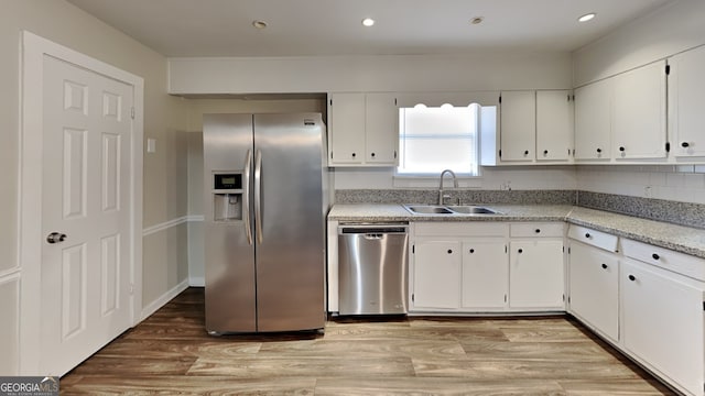 kitchen with white cabinetry, sink, and appliances with stainless steel finishes