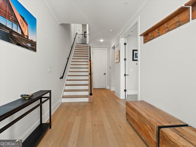 interior space with ornamental molding and hardwood / wood-style flooring