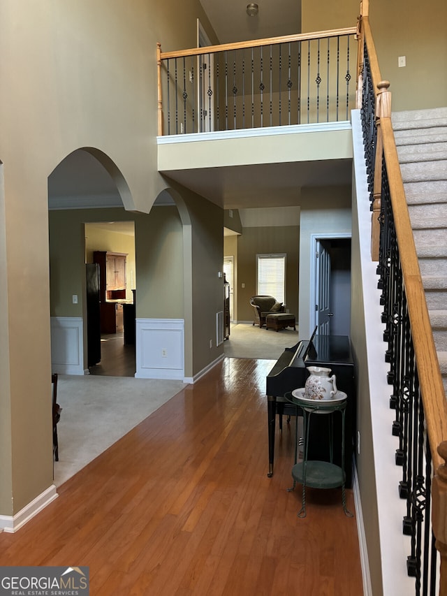 foyer featuring a high ceiling and hardwood / wood-style flooring