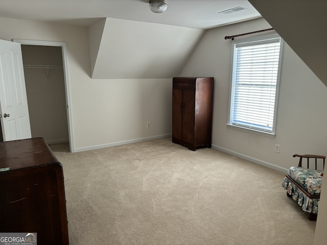 bonus room featuring light colored carpet and lofted ceiling