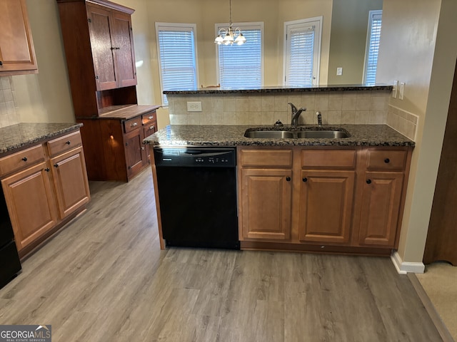 kitchen with dishwasher, backsplash, sink, light hardwood / wood-style floors, and a chandelier