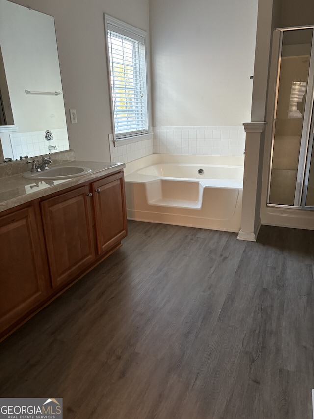 bathroom featuring wood-type flooring, vanity, and independent shower and bath