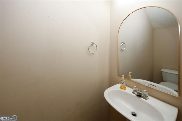 bathroom featuring sink and toilet