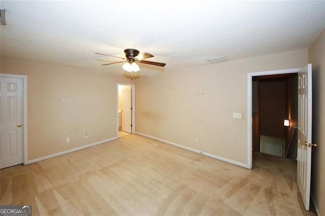 carpeted empty room with a textured ceiling and ceiling fan