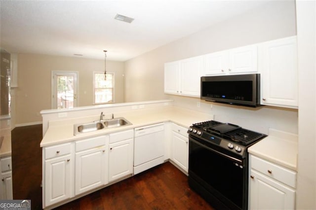 kitchen featuring white dishwasher, black range, and kitchen peninsula