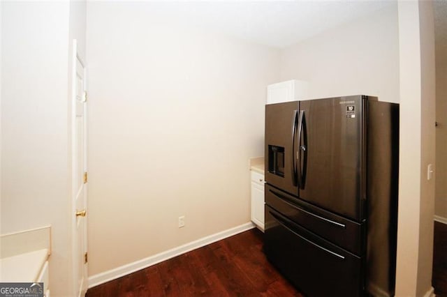 details with white cabinets, stainless steel fridge with ice dispenser, and dark wood-type flooring