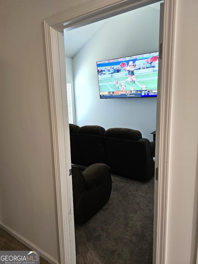 carpeted living room featuring vaulted ceiling