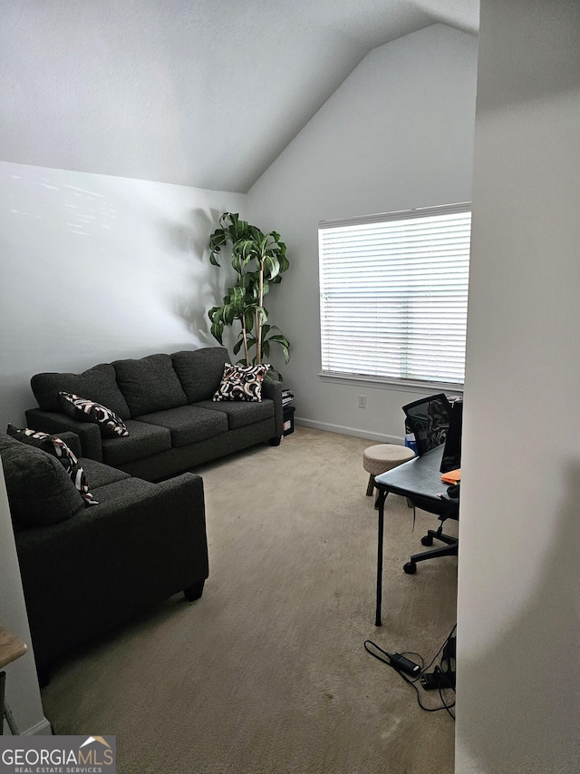 living room featuring carpet and vaulted ceiling