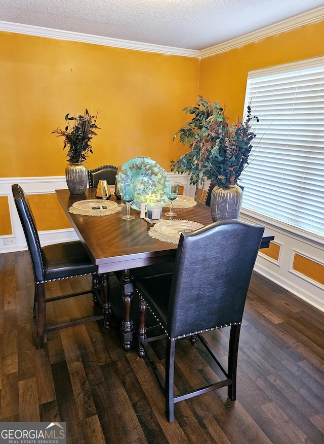 dining room featuring a textured ceiling, dark hardwood / wood-style floors, and ornamental molding